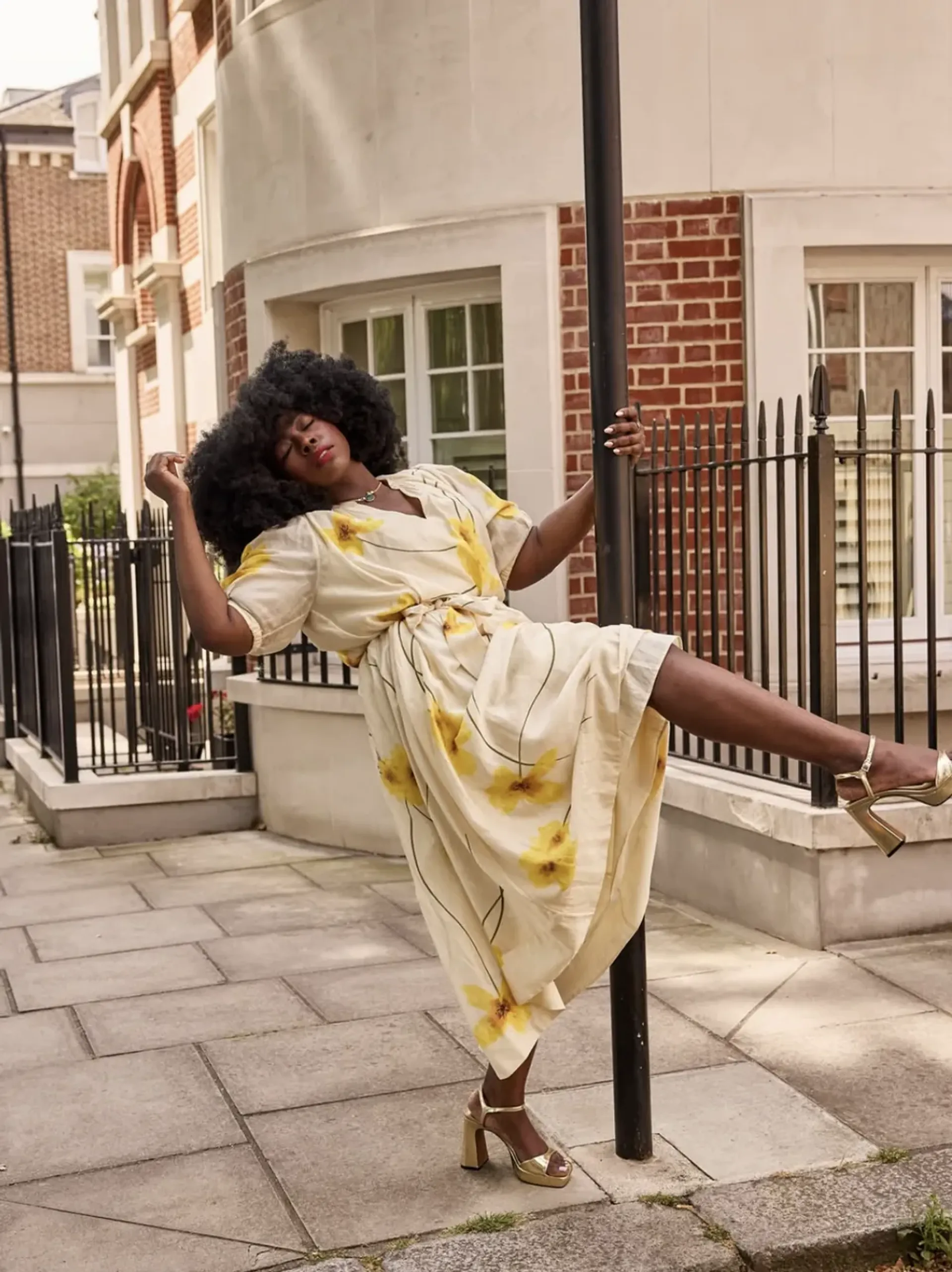 Stephanie Yeboah wearing a yellow floral dress outdoors
