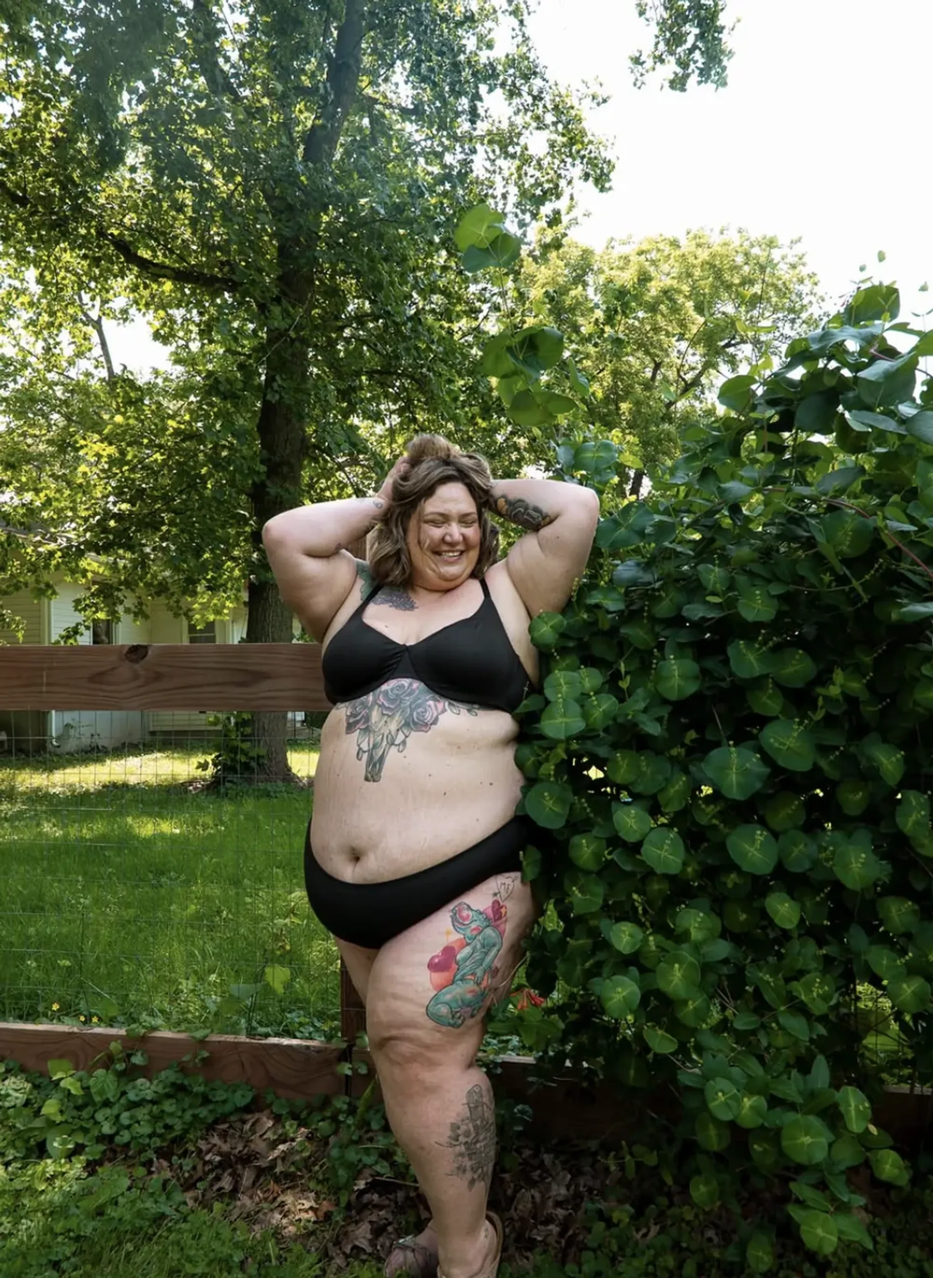 Alicia Mccarvell smiling outdoors in a black bikini