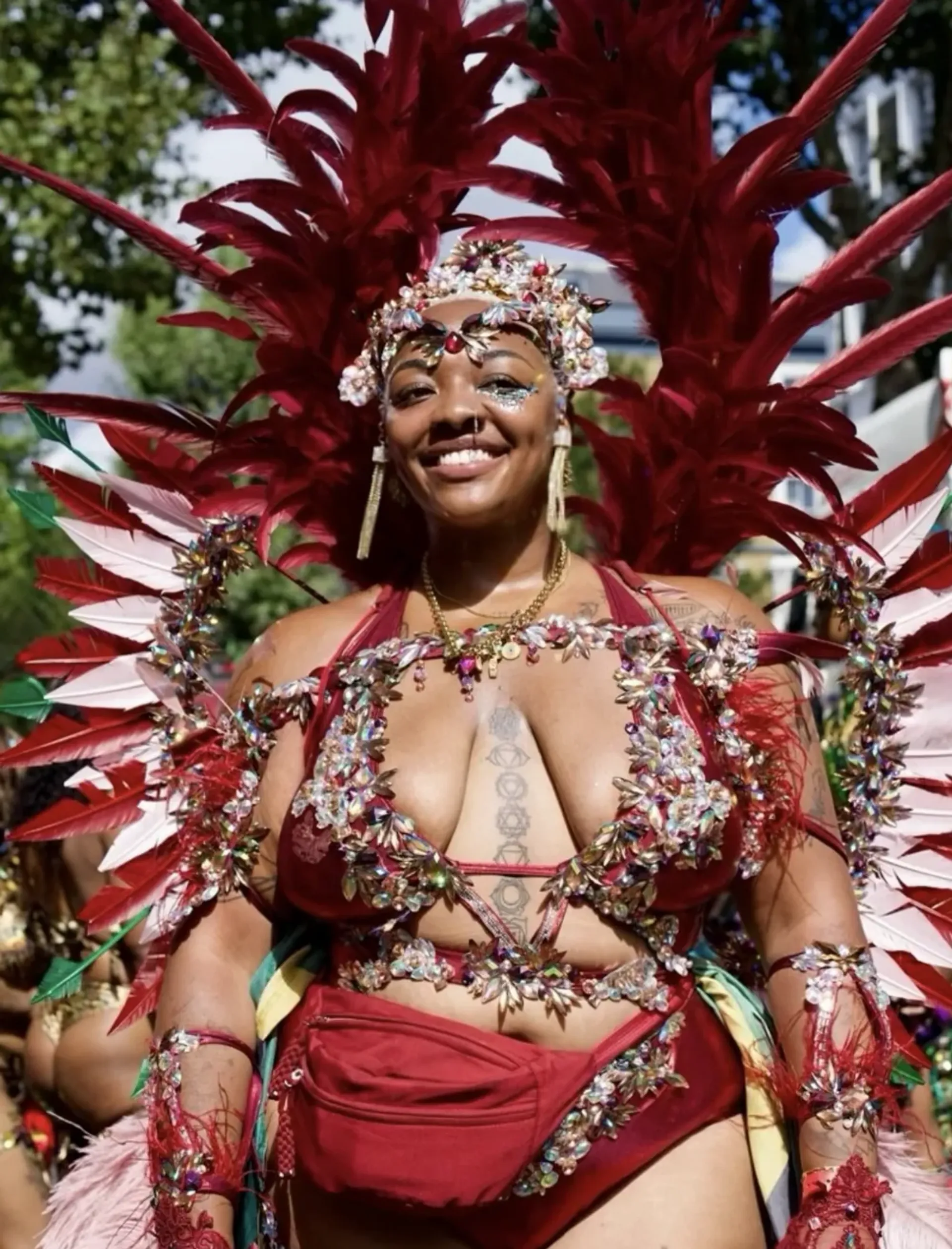 Nyome Nicholas-Williams in a red carnival-inspired outfit