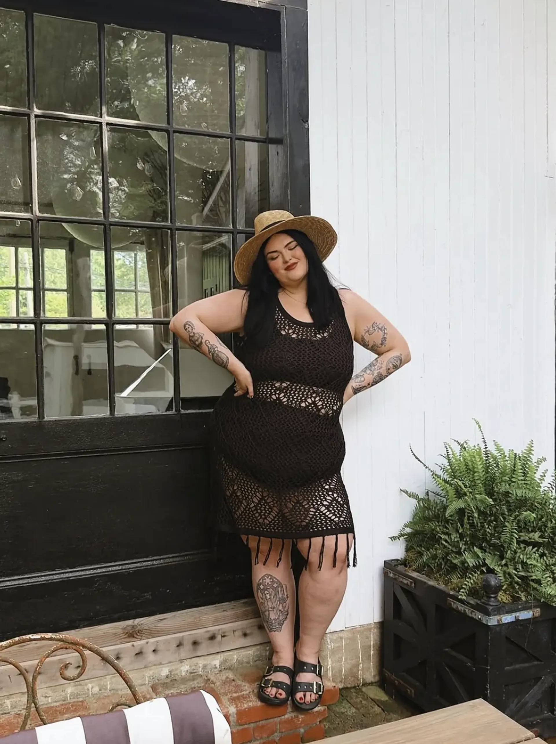 Rosey Blair wearing a black crochet dress and sun hat