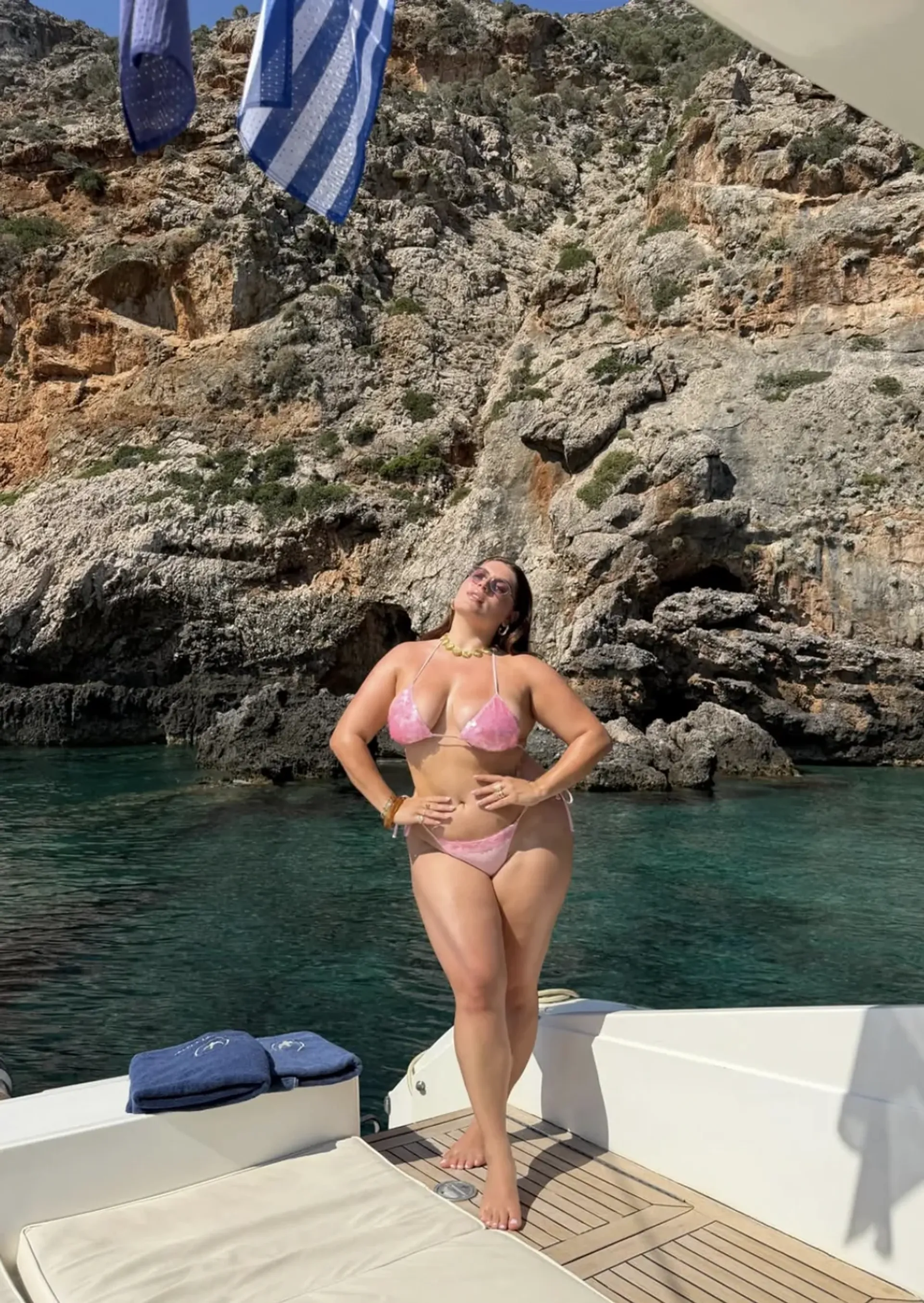 Gabriella Athena Halikas wearing a pink bikini on a yacht