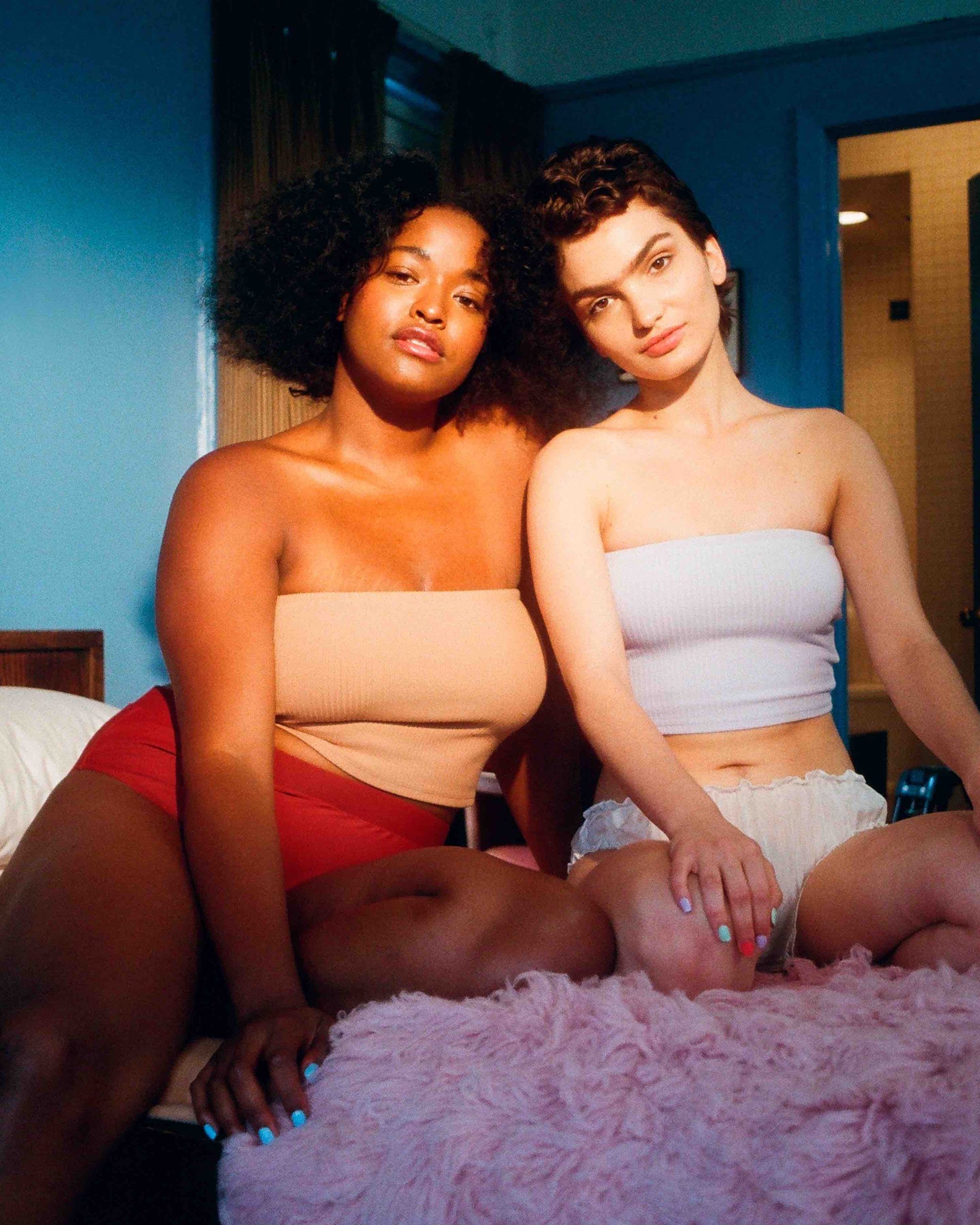 Two Body Positive Woman Sitting on Bed